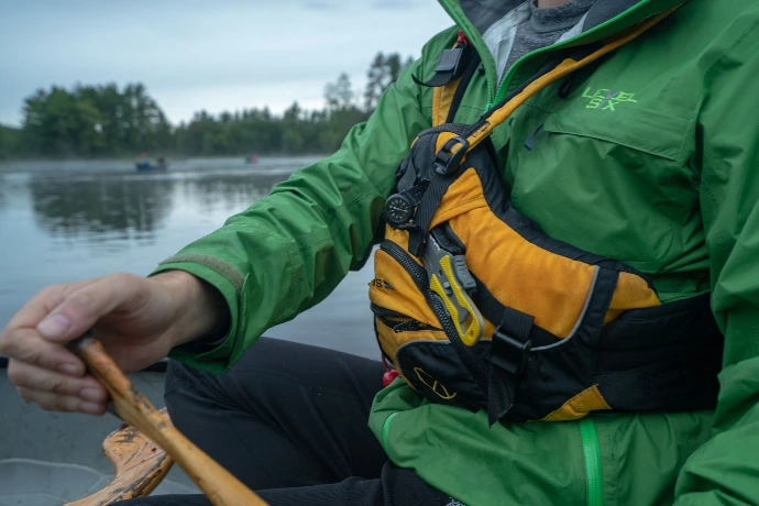 Close up of a canoeist wearing a yellow life jacket